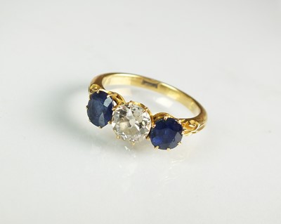 Lot 127 - A late 19th century three stone diamond and sapphire ring