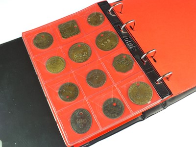Lot 219 - An album containing fifty-one brass and white metal colliery and associated tokens