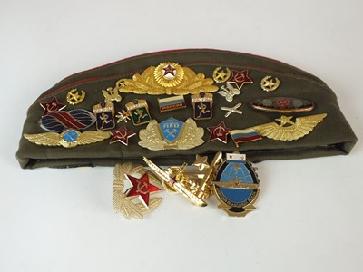 Lot 89 - A Russian sidecap with twenty-two badges...