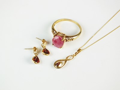 Lot 245 - A ruby ring and a suite of garnet jewellery