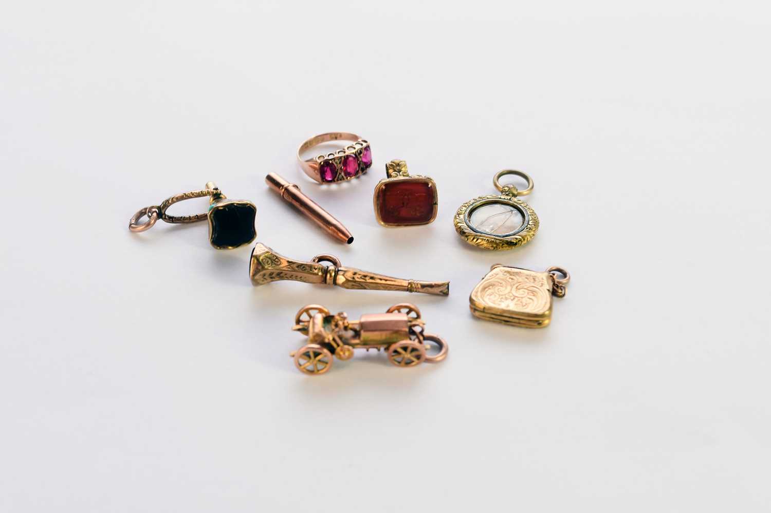 Lot 313 - A collection of fobs/charms and a ring