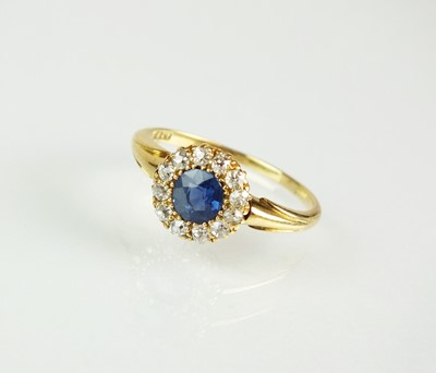 Lot 70 - A late 19th century sapphire and diamond cluster ring