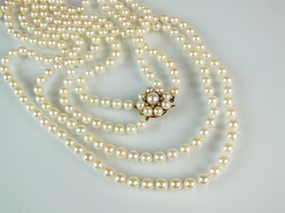 Lot 65 - An Opera length two strand uniform cultured pearl necklace and a single cultured pearl earring