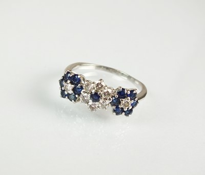 Lot 44 - A sapphire and diamond floral cluster ring and earrings