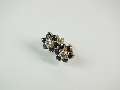 Lot 44 - A sapphire and diamond floral cluster ring and earrings