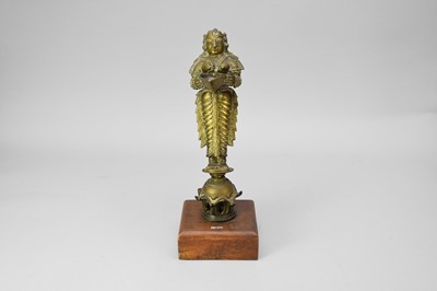 Lot 651 - An Indian Brass Figure of Lakshmi / Deepalakshmi, 19th century