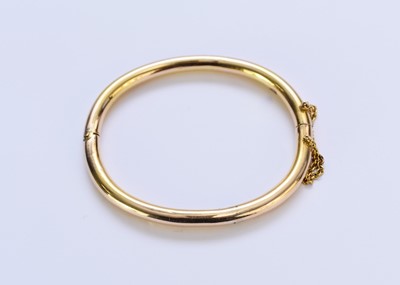 Lot 143 - A yellow metal hollow bangle