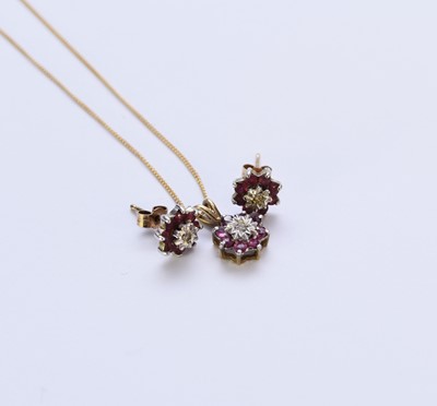 Lot 141 - A ruby and diamond pendant and a pair of earrings
