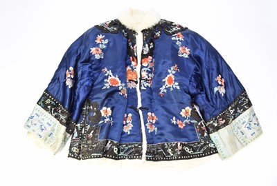 Lot 484 - A Chinese embroidered silk winter jacket