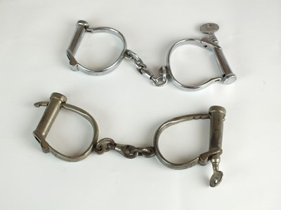 Lot 127 - Two pairs of "D-Type" handcuffs by Hiatt and Dowler