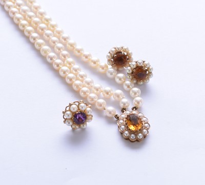 Lot 130 - A 9ct gold three strand uniform cultured pearl bracelet and earrings