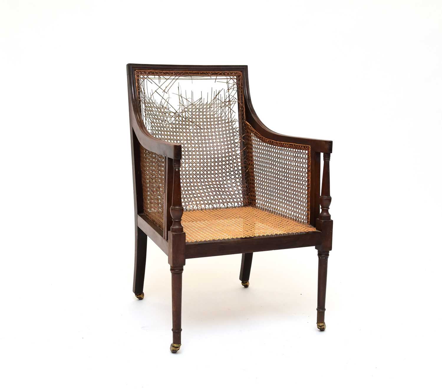 Lot 575 - A George IV library bergere chair