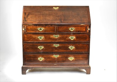 Lot 563 - A George III cross-banded oak bureau