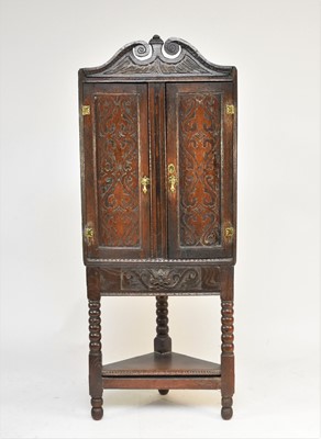 Lot 596 - A 17th century and later oak corner cabinet