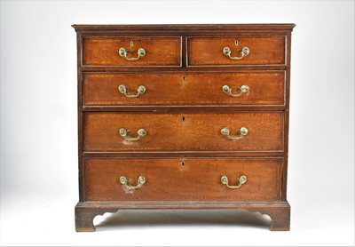Lot 568 - A George III cross-banded oak chest of drawers