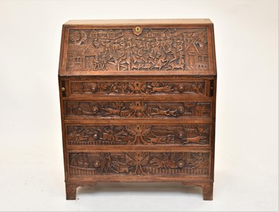 Lot 653 - A 19th century carved oak fall-front bureau