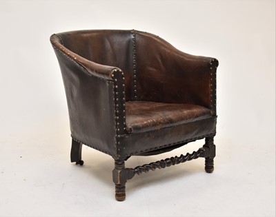 Lot 610 - An early 20th century hide covered tub chair