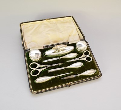Lot 68 - A cased silver mounted manicure set