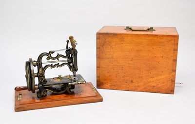 Lot 508 - A Weir-Raymond sewing machine in wood carrying case