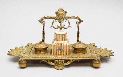 Lot 568 - A late Victorian brass standish, or inkstand and a porcelain inkwell (2)