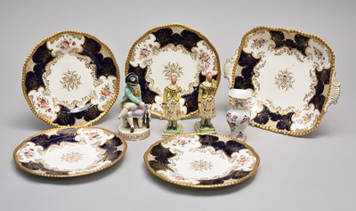 Lot 302 - A collection of porcelain, including a Meissen model of a seated boy and Coalport batwing service