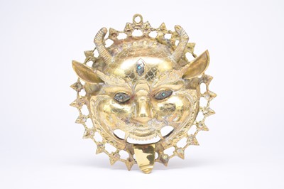 Lot 424 - A Tibetan brass Yama mask