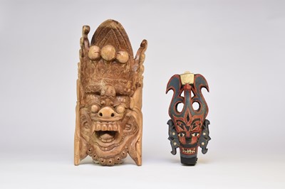 Lot 483 - A Balinese wall mask and three Malaysian wood masks