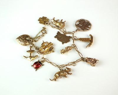 Lot 69 - A yellow metal bracelet with attached yellow metal and 9ct gold charms