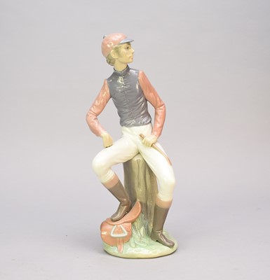 Lot 372 - A Lladro model of a male jockey, gloss, 34cm high