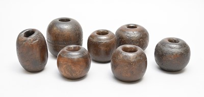 Lot 502 - A group of seven lignum vitae horse tethering weights