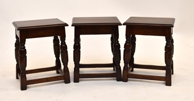 Lot 569 - A set of three Waring & Gillow oak stools