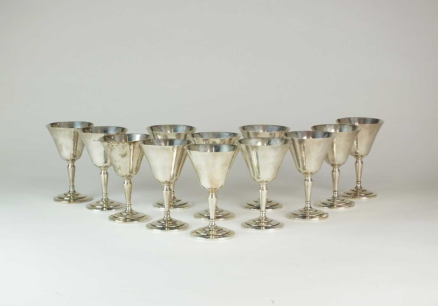 Lot 27 - A set of twelve silver goblets
