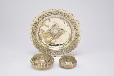 Lot 215 - A Balinese embossed silver dish together with two similar powder/shot flasks