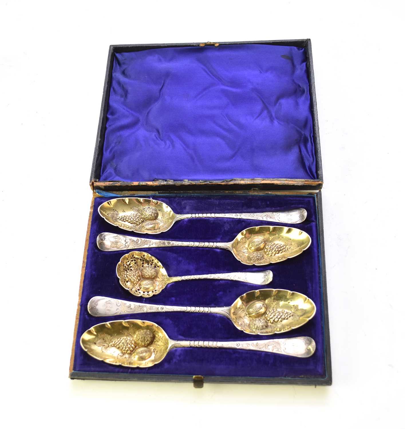 Lot 14 - A matched set of four later embossed silver fruit spoons and sugar sifter spoon