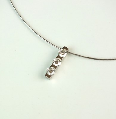 Lot 123 - An 18ct white gold three stone diamond pendant on chain