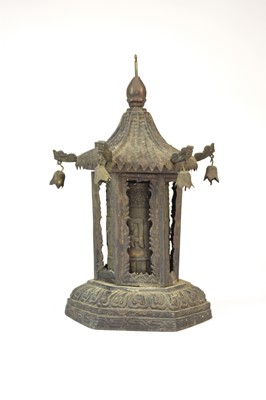 Lot 487 - A Tibetan pressed metal prayer wheel