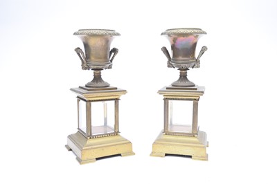 Lot 317 - A pair of brass campana urns