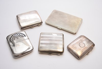 Lot 51 - A collection of four silver cigarette cases and a plated hand warmer