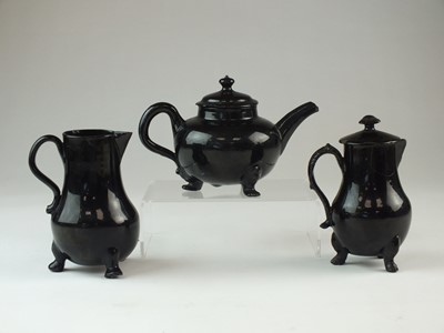 Lot 97 - Jackfield teapot and two cream jugs, circa 1750-60