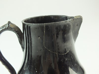 Lot 97 - Jackfield teapot and two cream jugs, circa 1750-60