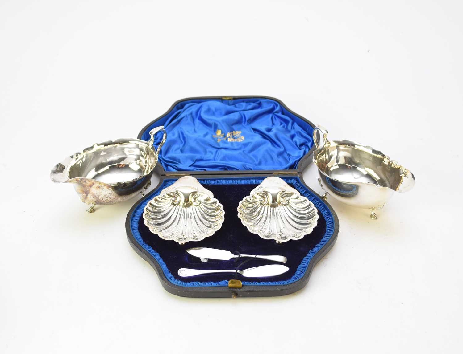 Lot 24 - A pair of silver sauce boats and a cased pair of silver butter dishes