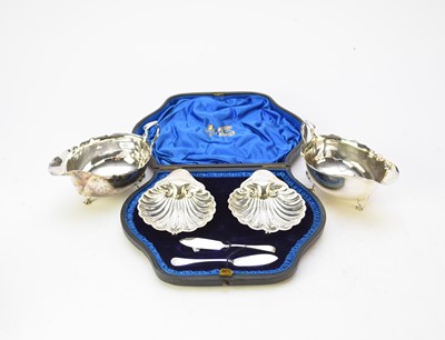Lot 24 - A pair of silver sauce boats and a cased pair of silver butter dishes