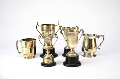Lot 26 - Two silver mugs and four silver trophies