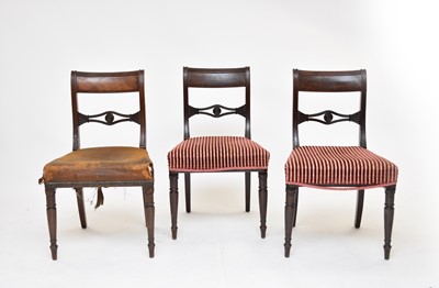 Lot 669 - A set of eight Regency mahogany and ebony strung sabre-leg dining chairs