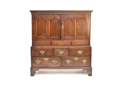 Lot 690 - A George III oak livery cupboard