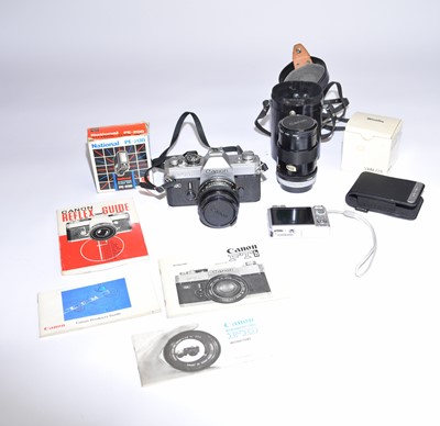 Lot 630 - A Canon FTb 35mm SLR camera with lenses and a Sony cybershot digital camera