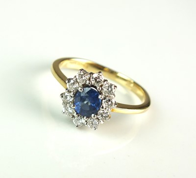Lot 25 - An 18ct gold sapphire and diamond cluster ring