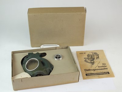 Lot 230 - Two German Third Reich gas mask respirator tins and a German civilian VM40 respirator