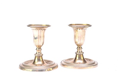Lot 49 - A pair of George III dwarf silver candlesticks