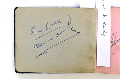 Lot 1107 - STAN LAUREL AND OLIVER HARDY autographs in an album.